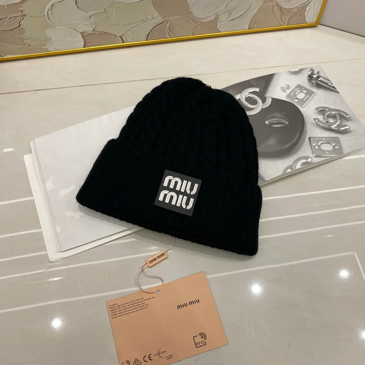 Miu Miu Cable-knit logo beanie in Black & White & Grey & Tan & Cream & Burgundy & Brown · view 1