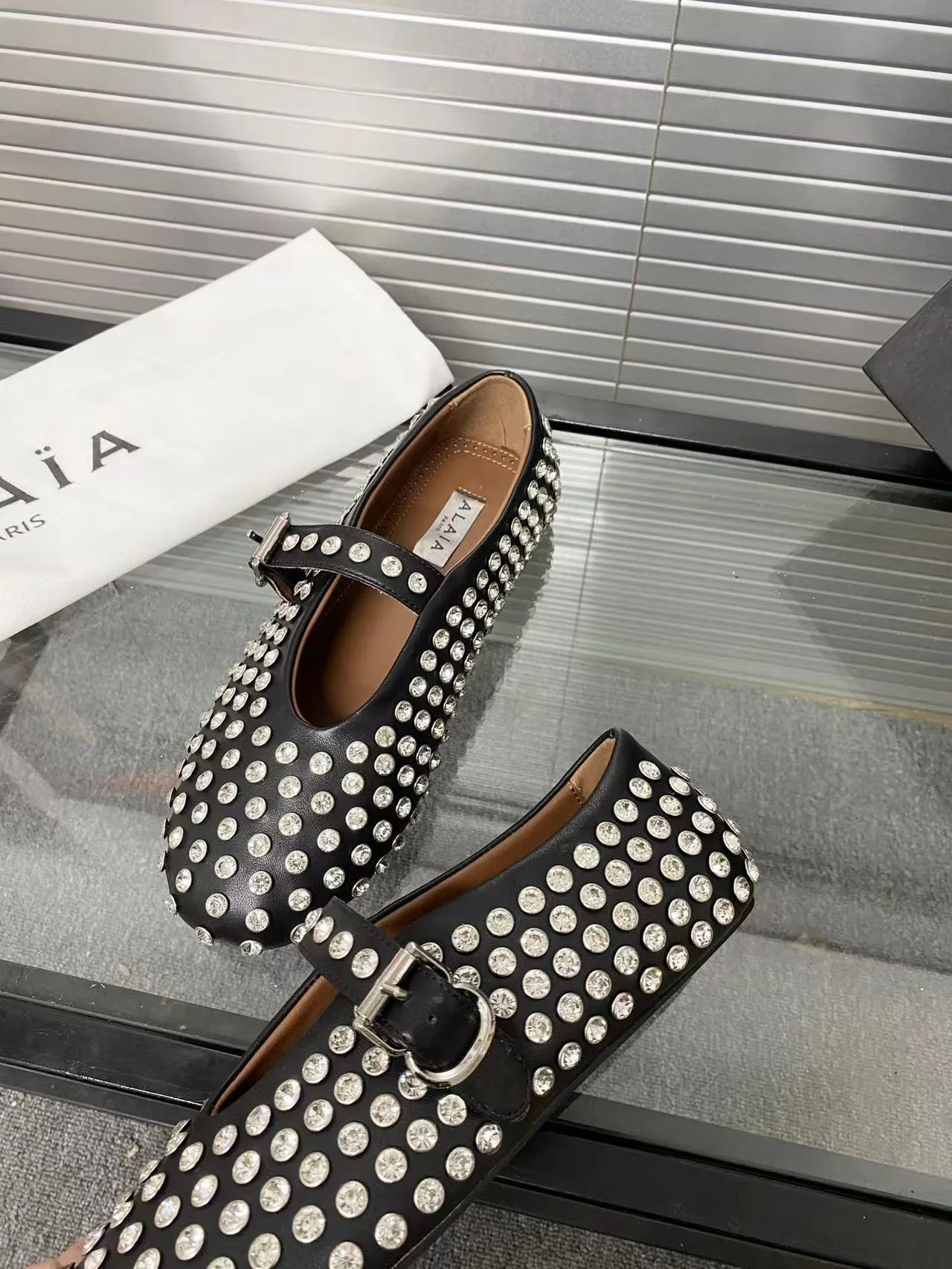 Alaia Cowhide Sheepskin Buckle Studded Mary Jane Flats in Black · view 7