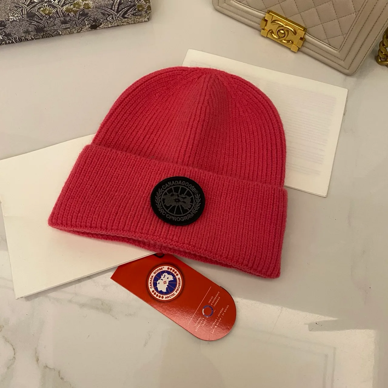 Canada Goose Logo knit beanie in Red & Blue & Yellow & Orange & Pink & Grey & White & Black & Tan & Cream · view 1