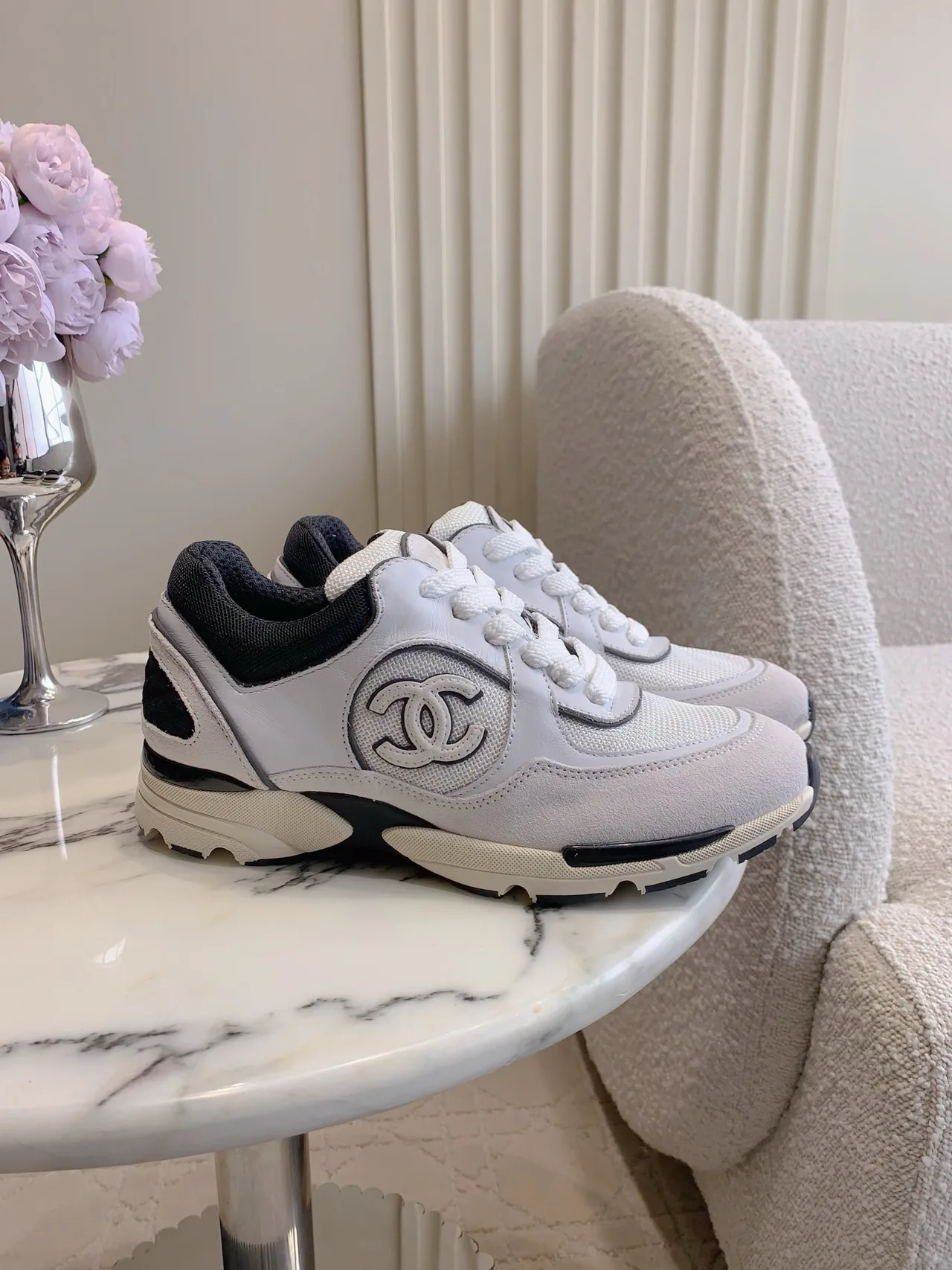 Chanel Quilted Sneakers in White · view 1