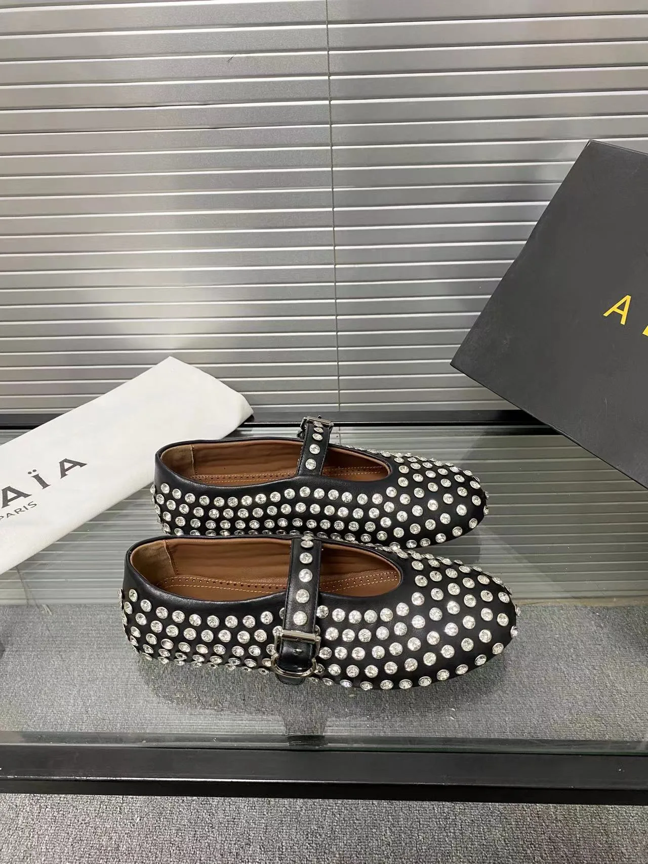 Alaia Cowhide Sheepskin Buckle Studded Mary Jane Flats in Black · view 1