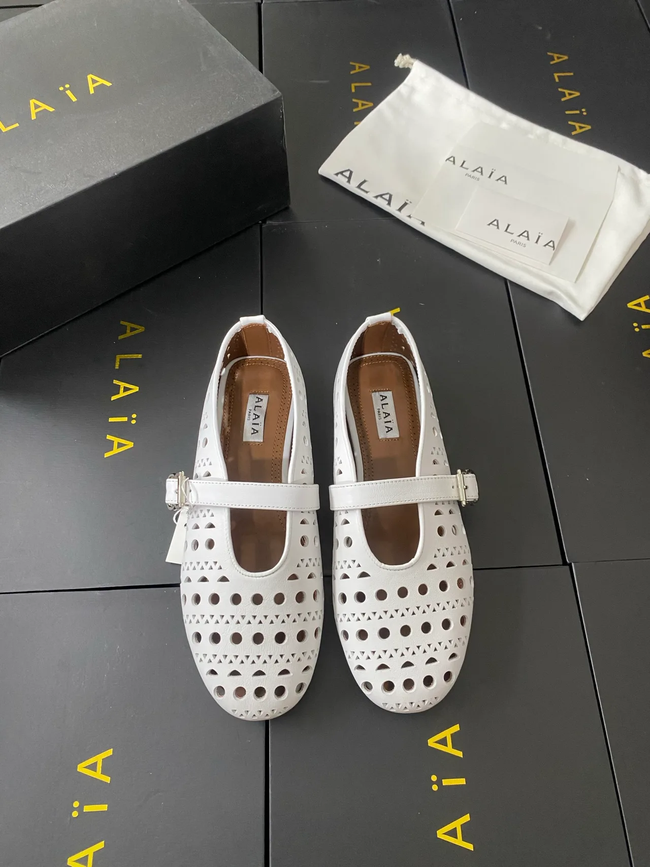 Alaia Cowhide Sheepskin Round-Toe Buckle Ballet Flats in White · view 1