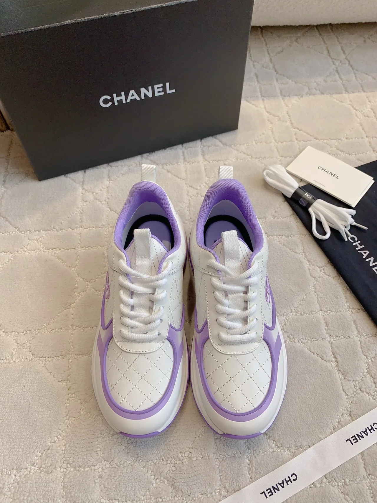 Chanel Quilted Sneakers in White · view 1