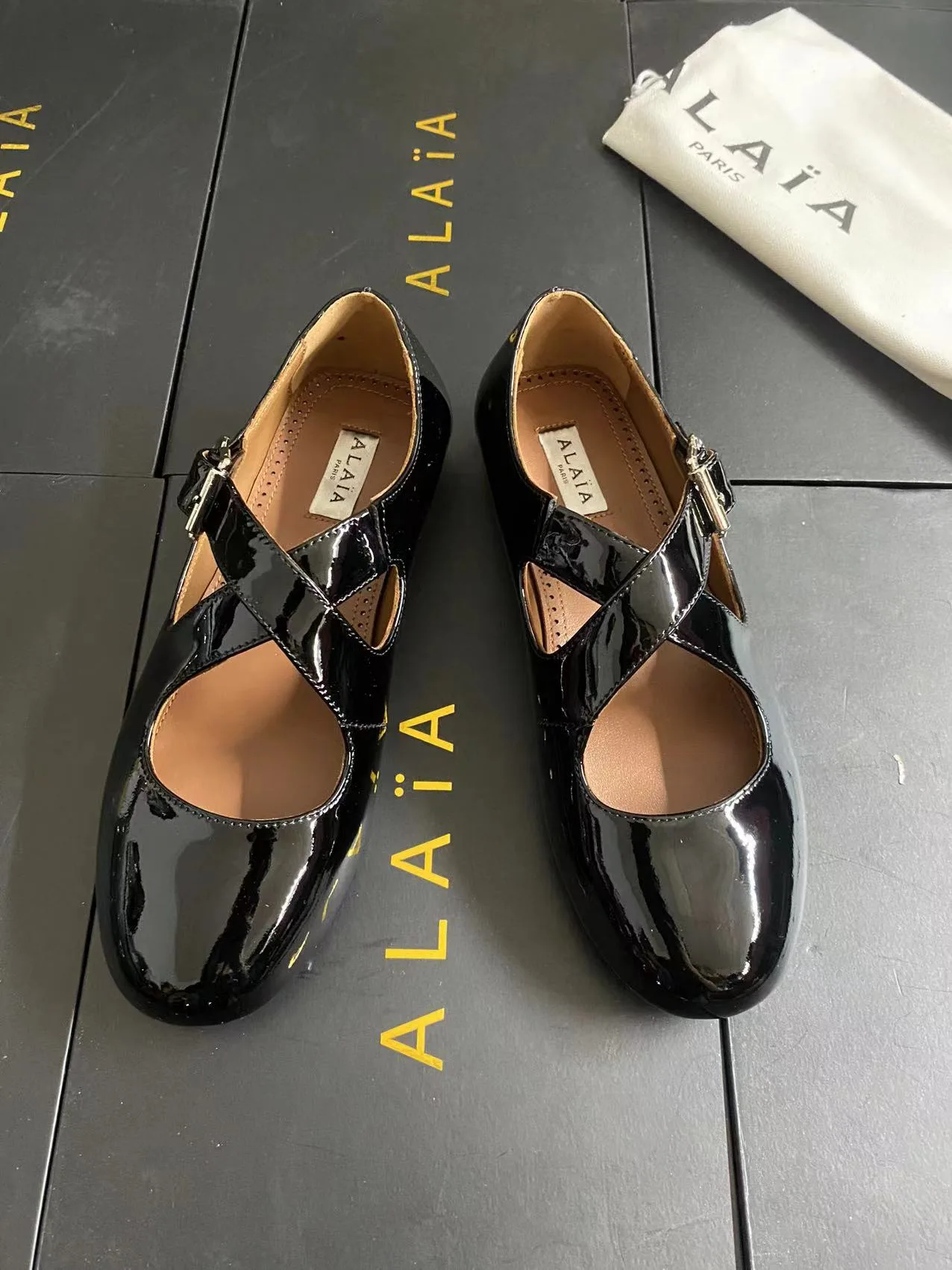 Alaia Cowhide Sheepskin Glossy Square-Toe Buckle Cross-Strap Flats in Black · view 6