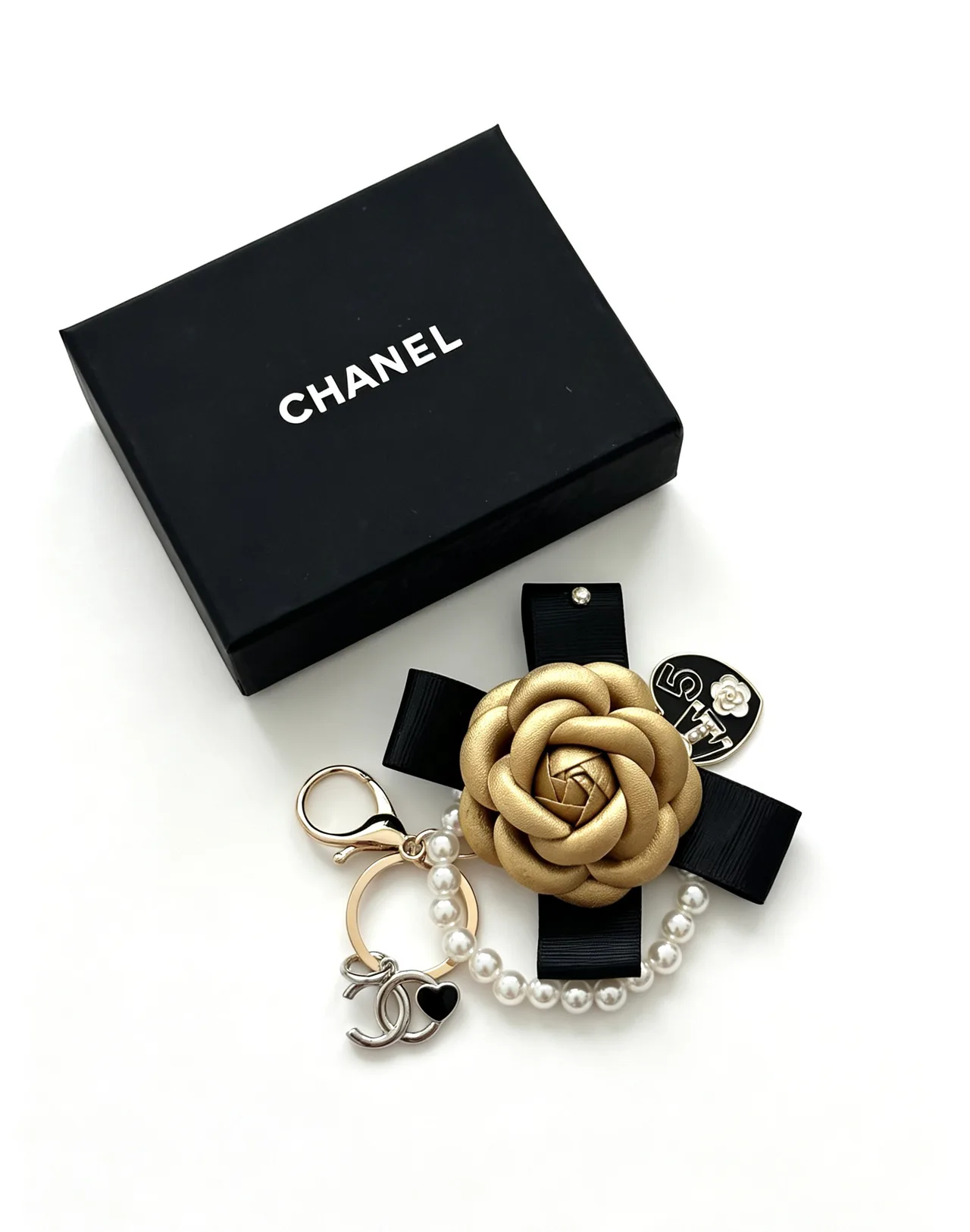Chanel Glossy Camellia Keychain in Gold · view 1