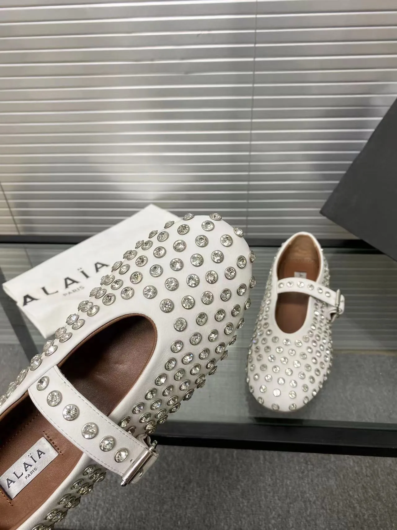 Alaia Cowhide Sheepskin Glossy Round-Toe Buckle Studded Mary Jane Flats in White · view 8