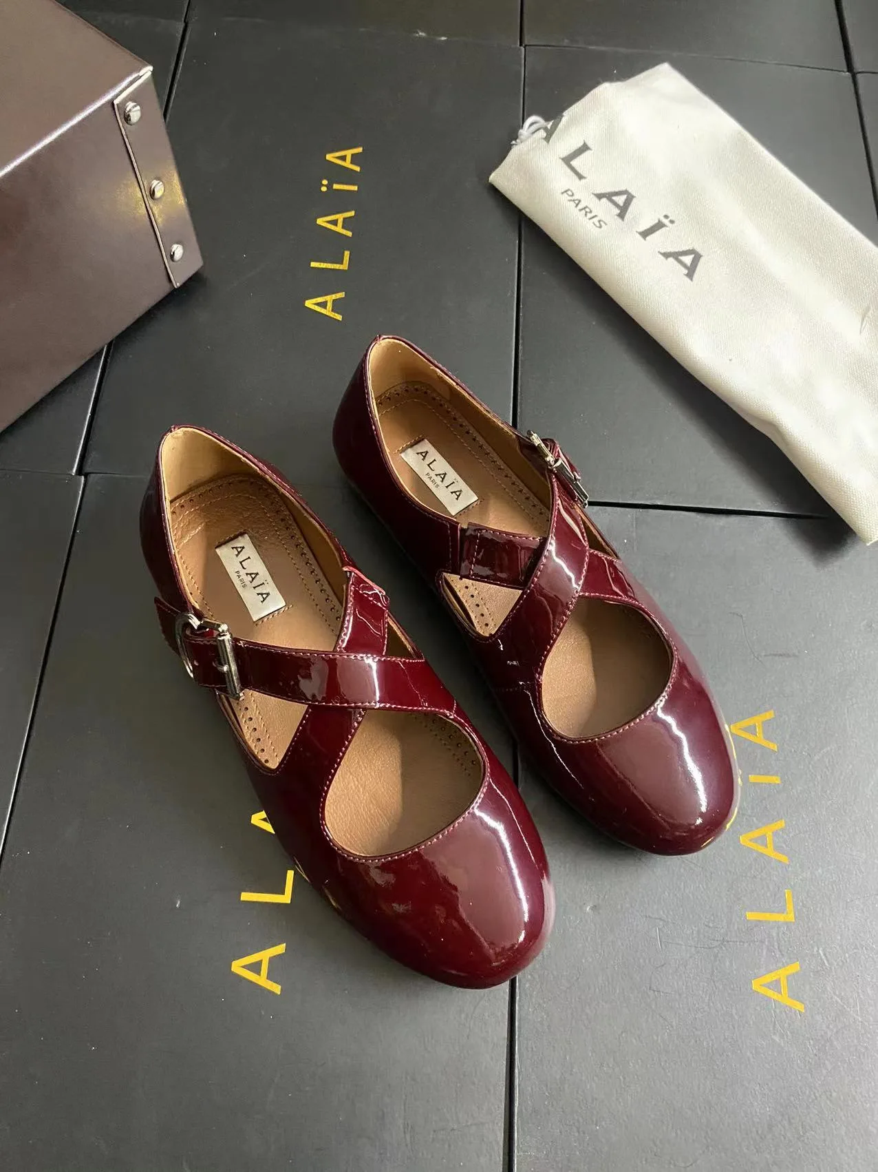 Alaia Cowhide Sheepskin Glossy Square-Toe Buckle Cross-Strap Mary Jane Flats in Burgundy · view 2