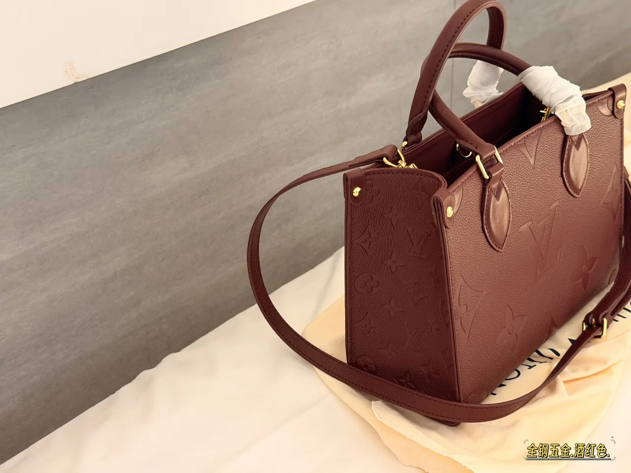 Louis Vuitton OnTheGo Embossed Monogram Zip-Compartment Tote in Burgundy · view 1