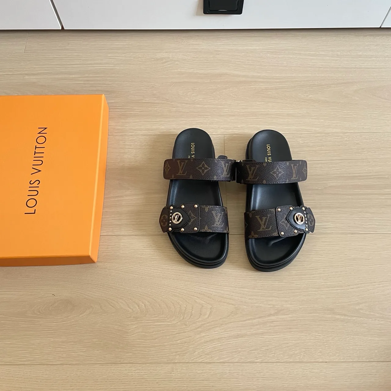 Louis Vuitton Cutout Slides in Black / Brown / Pink / Grey · view 1