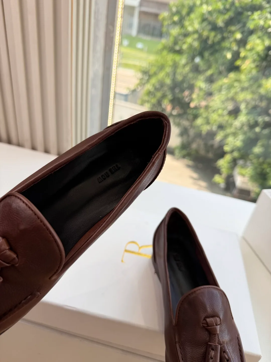 The Row Cowhide Glossy Round-Toe Tassel Loafers in Brown · view 6
