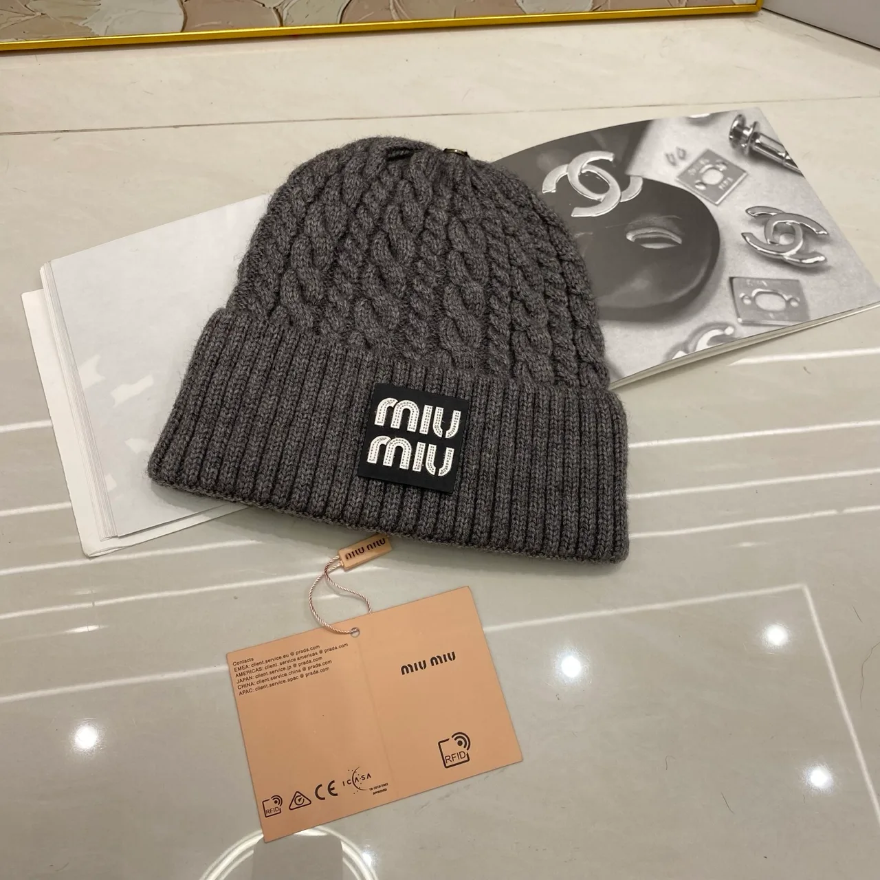 Miu Miu Cable-knit logo beanie in Black & White & Grey & Tan & Cream & Burgundy & Brown · view 3