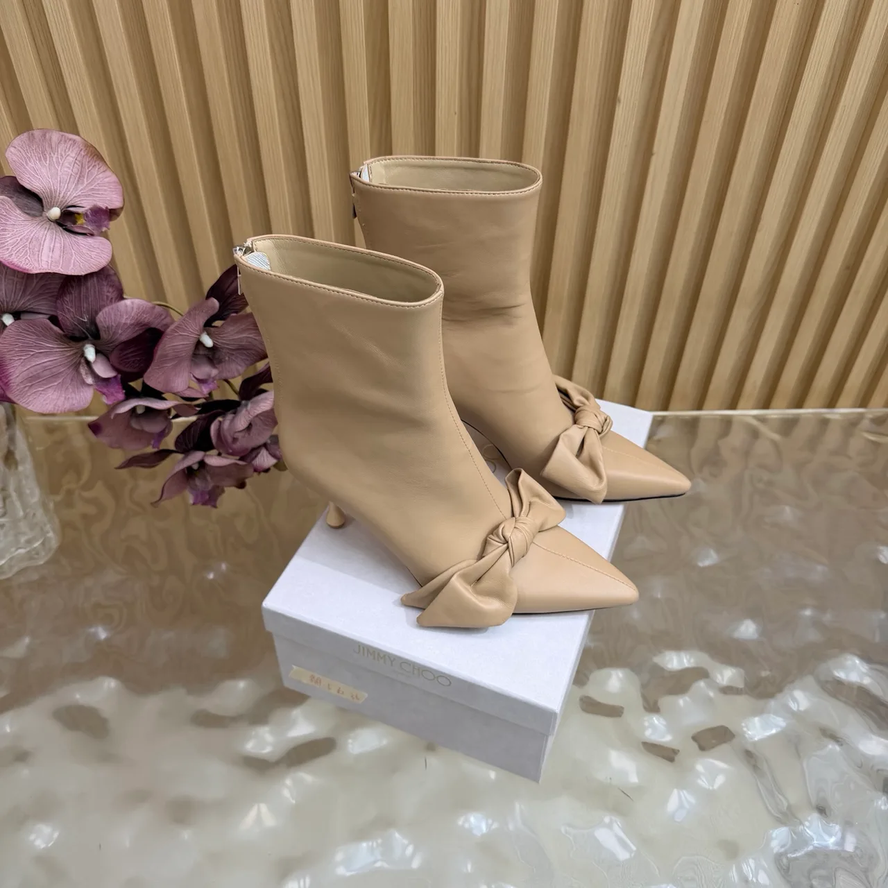 Jimmy Choo Cowhide Glossy Pointed-Toe Bow Ankle Boots in Beige · view 1