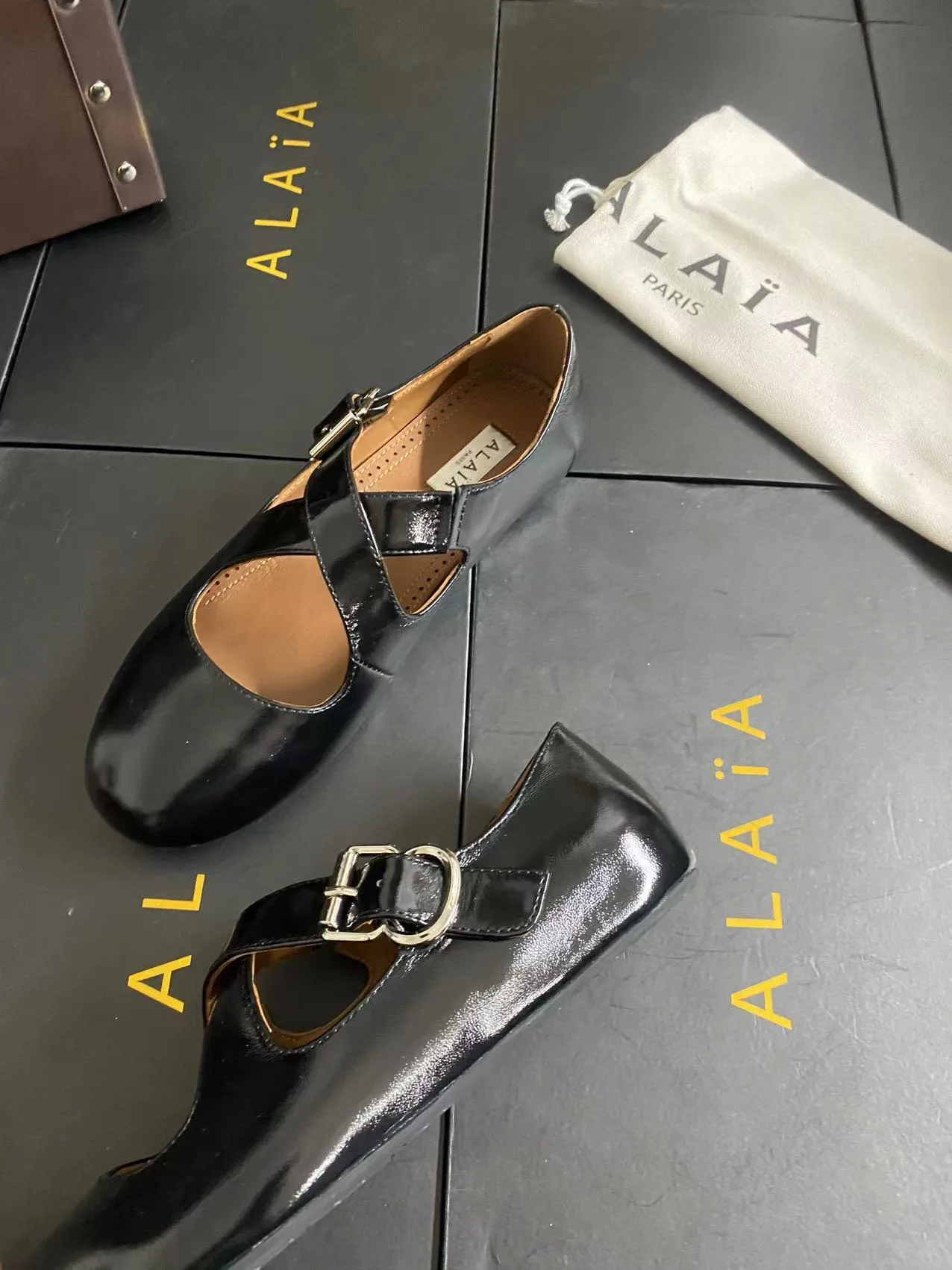 Alaia Cowhide Sheepskin Glossy Square-Toe Buckle Cross-Strap Flats in Black · view 3