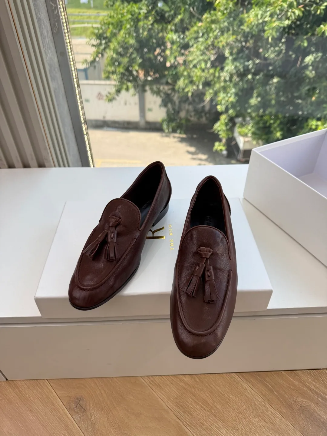 The Row Cowhide Glossy Round-Toe Tassel Loafers in Brown · view 1