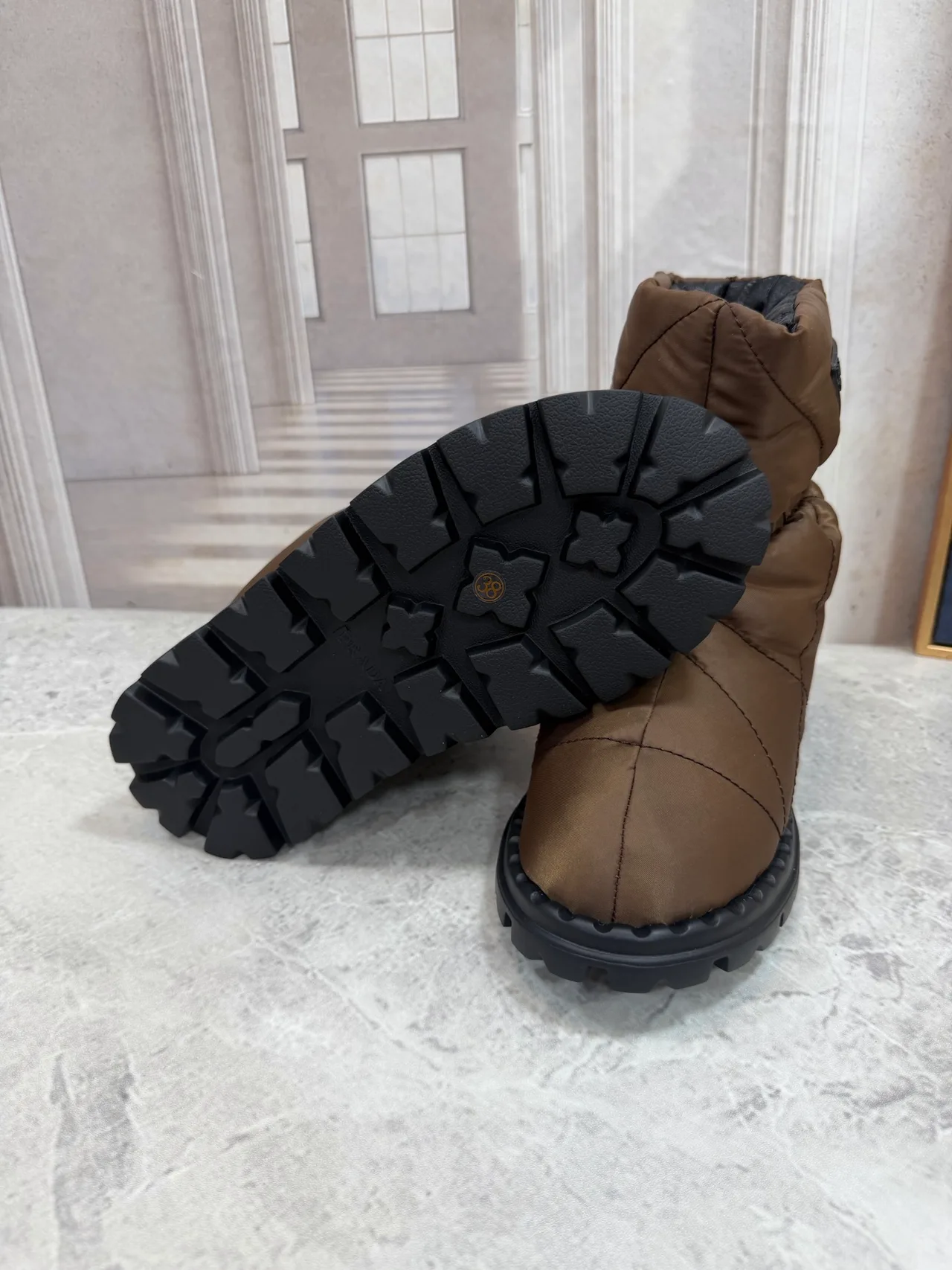 Prada Quilted Round-Toe Puffer Boots in Brown · view 8