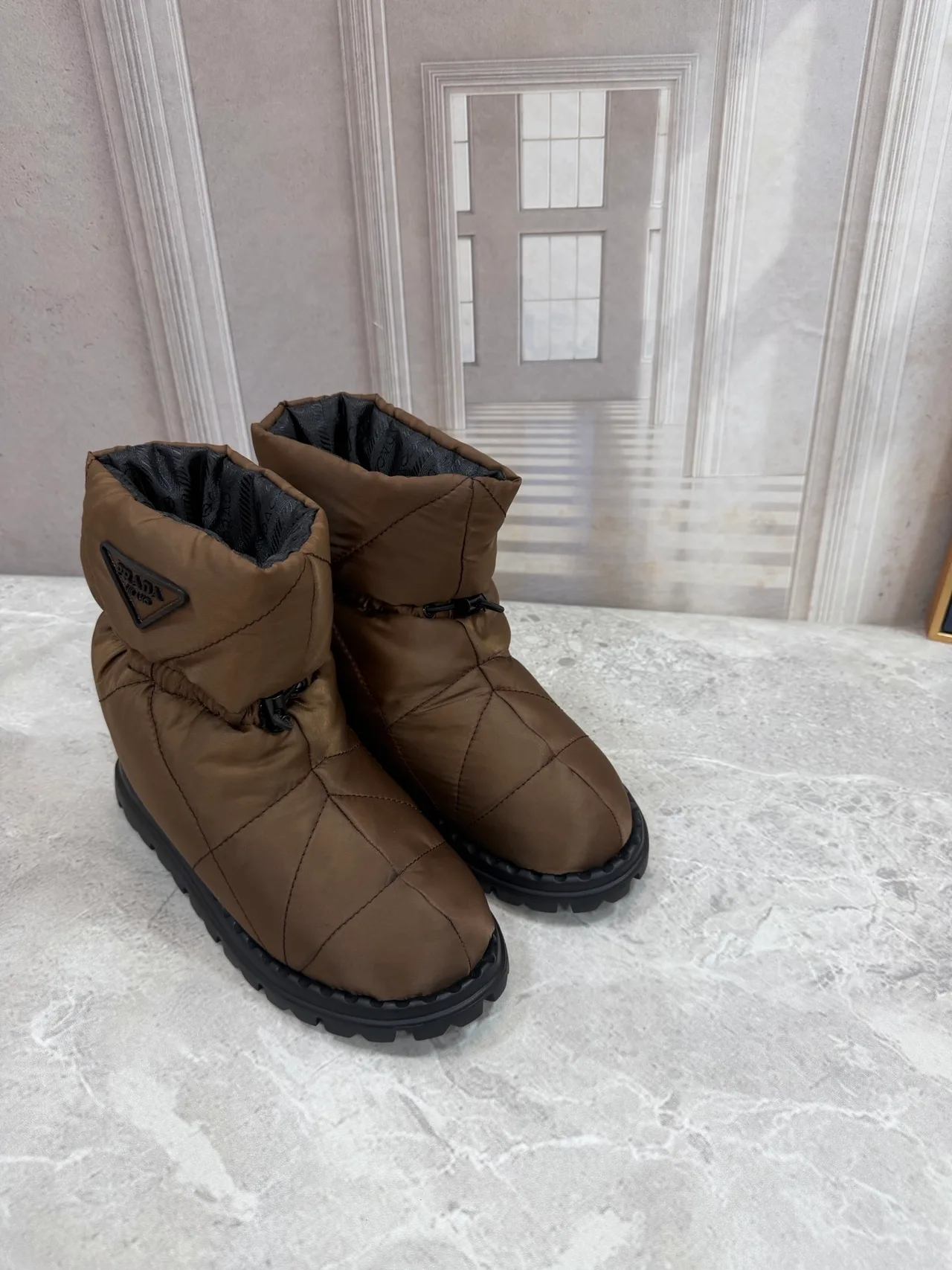 Prada Quilted Round-Toe Puffer Boots in Brown · view 1