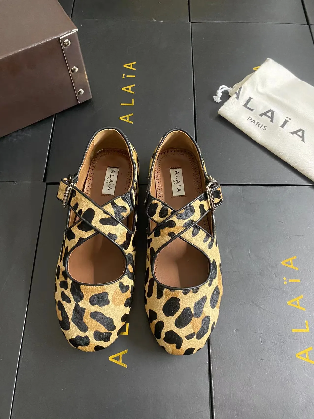 Alaia Cowhide Sheepskin Round-Toe Buckle Ballet Flats in Brown · view 1