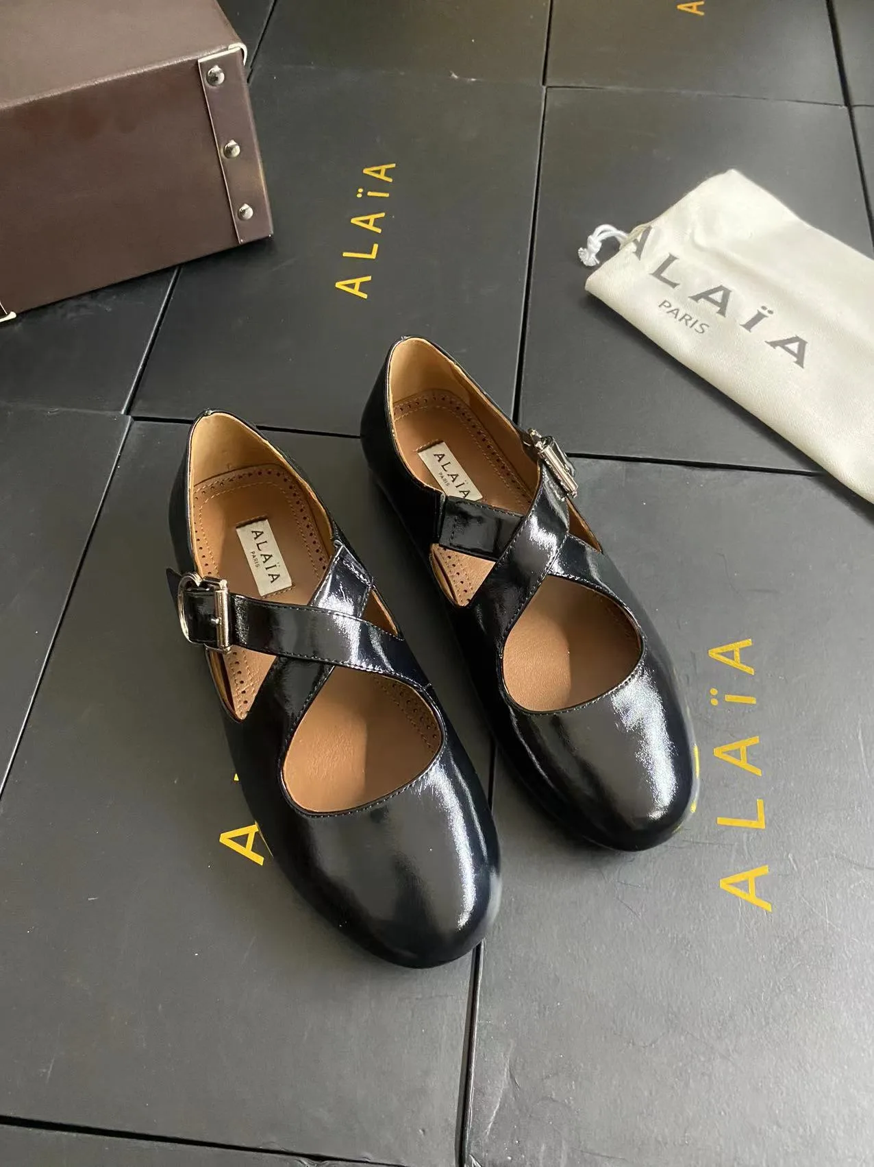 Alaia Cowhide Sheepskin Glossy Square-Toe Buckle Cross-Strap Flats in Black · view 2