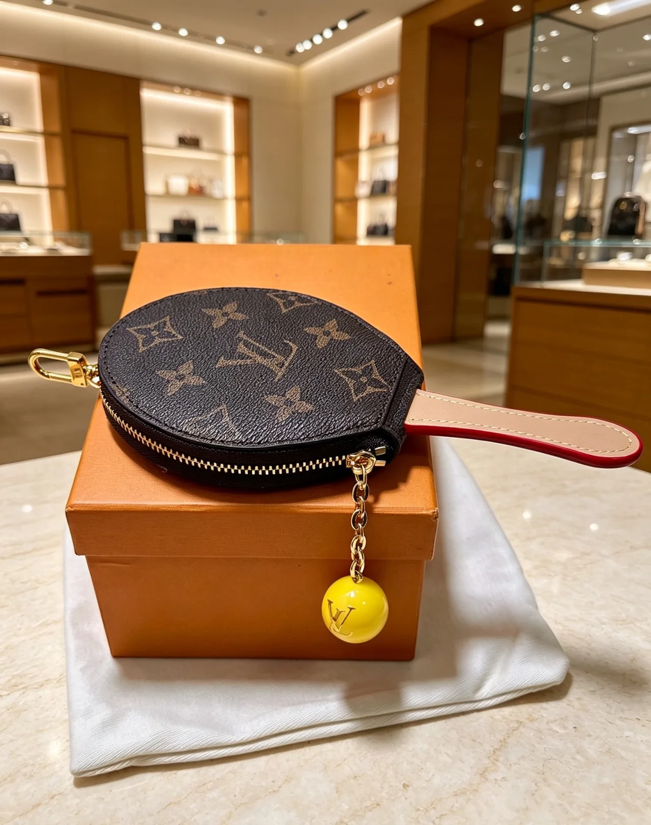 Louis Vuitton Racket-Shaped Coin Pouch in Brown & Red & Pink · view 1