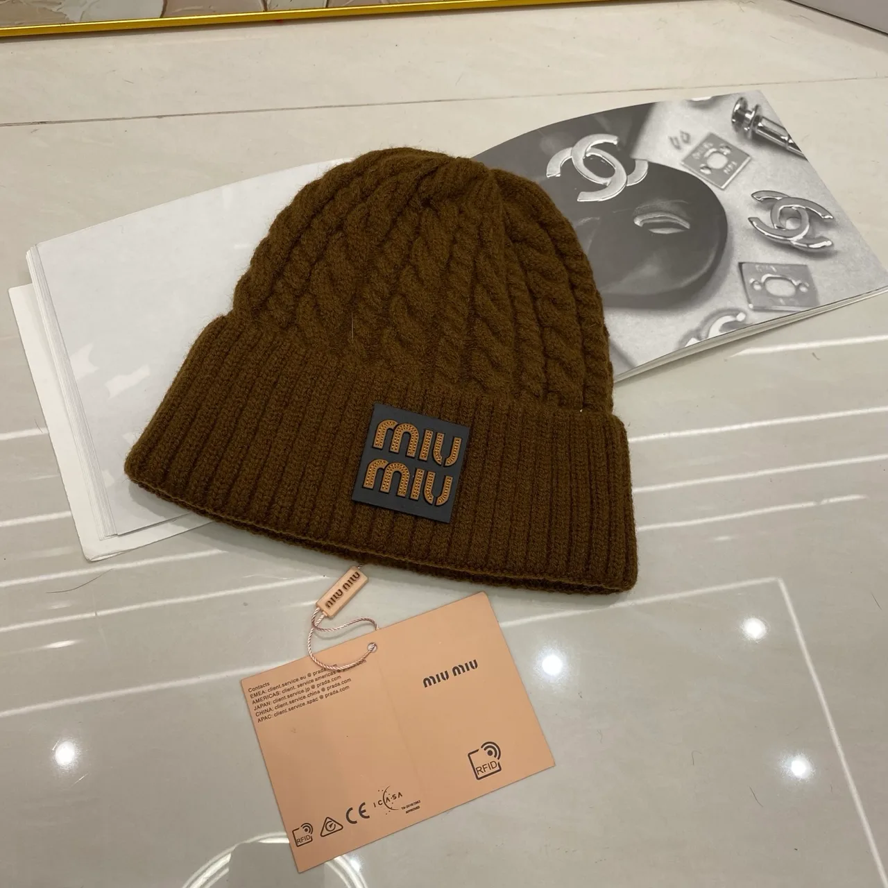 Miu Miu Cable-knit logo beanie in Black & White & Grey & Tan & Cream & Burgundy & Brown · view 7
