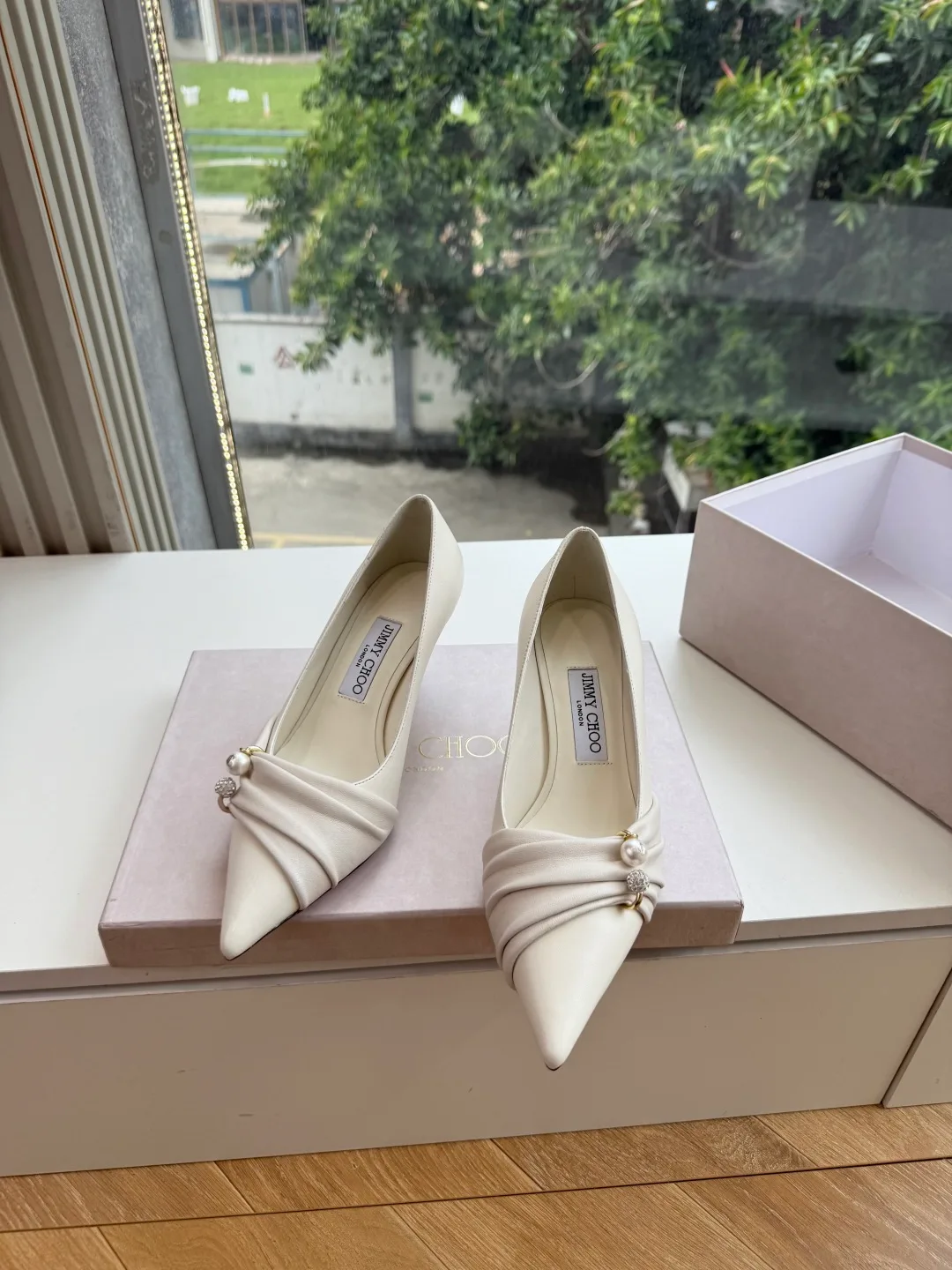 Jimmy Choo Glossy Pointed-Toe Knotted Pointed Pumps in White · view 2