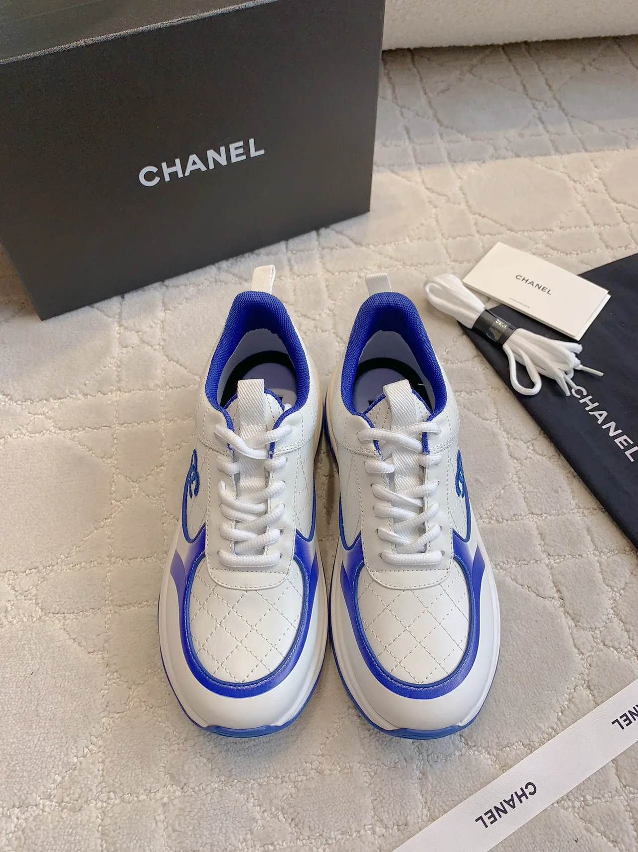 Chanel Quilted Sneakers in White · view 1