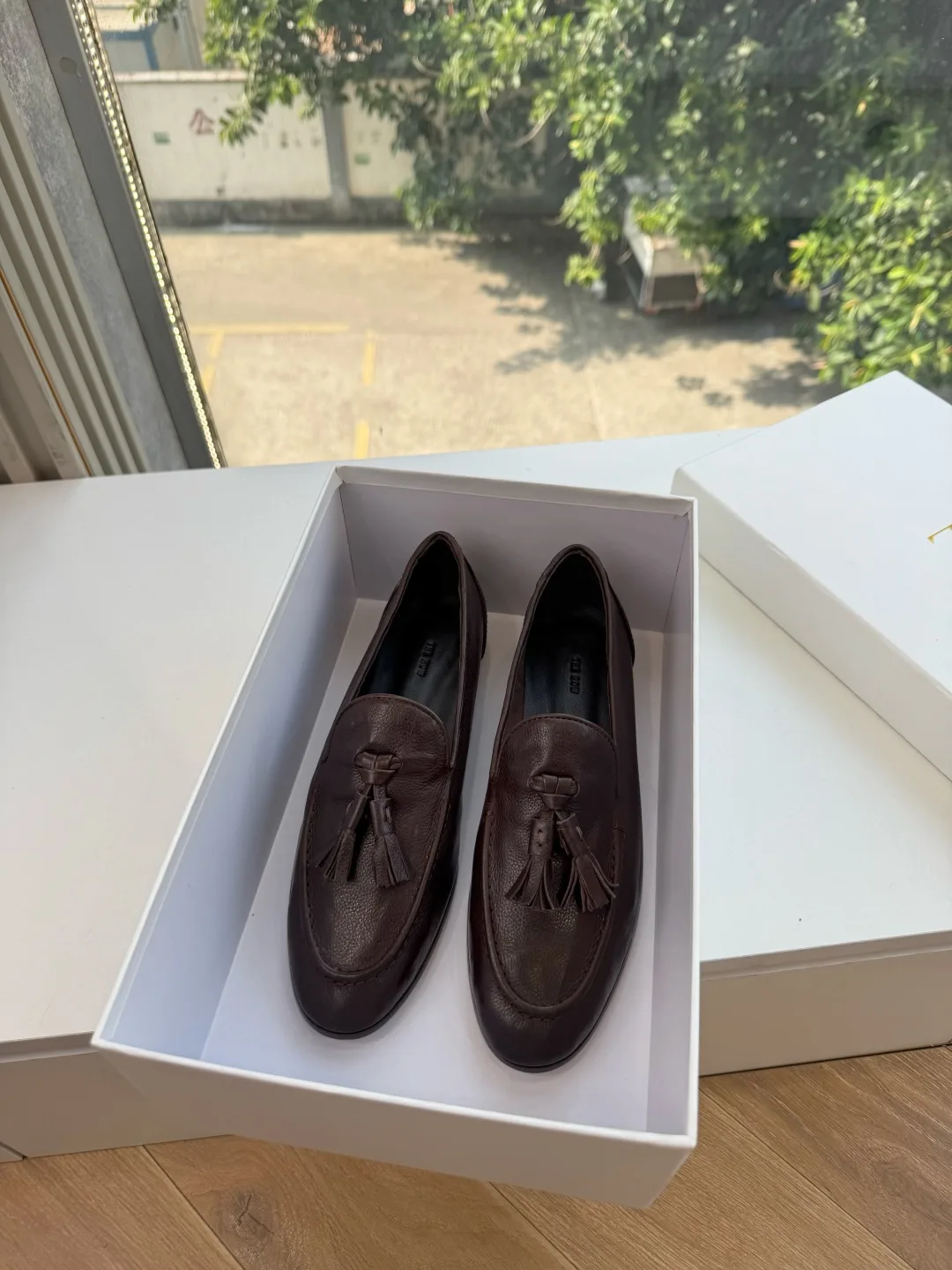 The Row Cowhide Glossy Round-Toe Tassel Loafers in Brown · view 1
