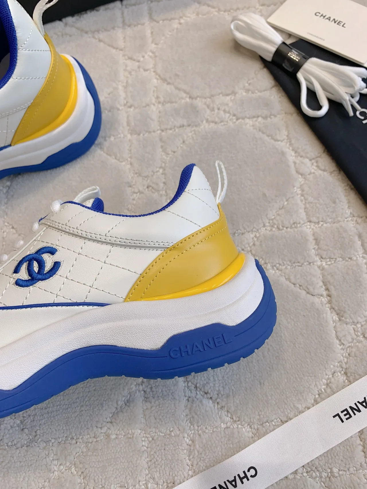 Chanel Quilted Sneakers in White · view 7