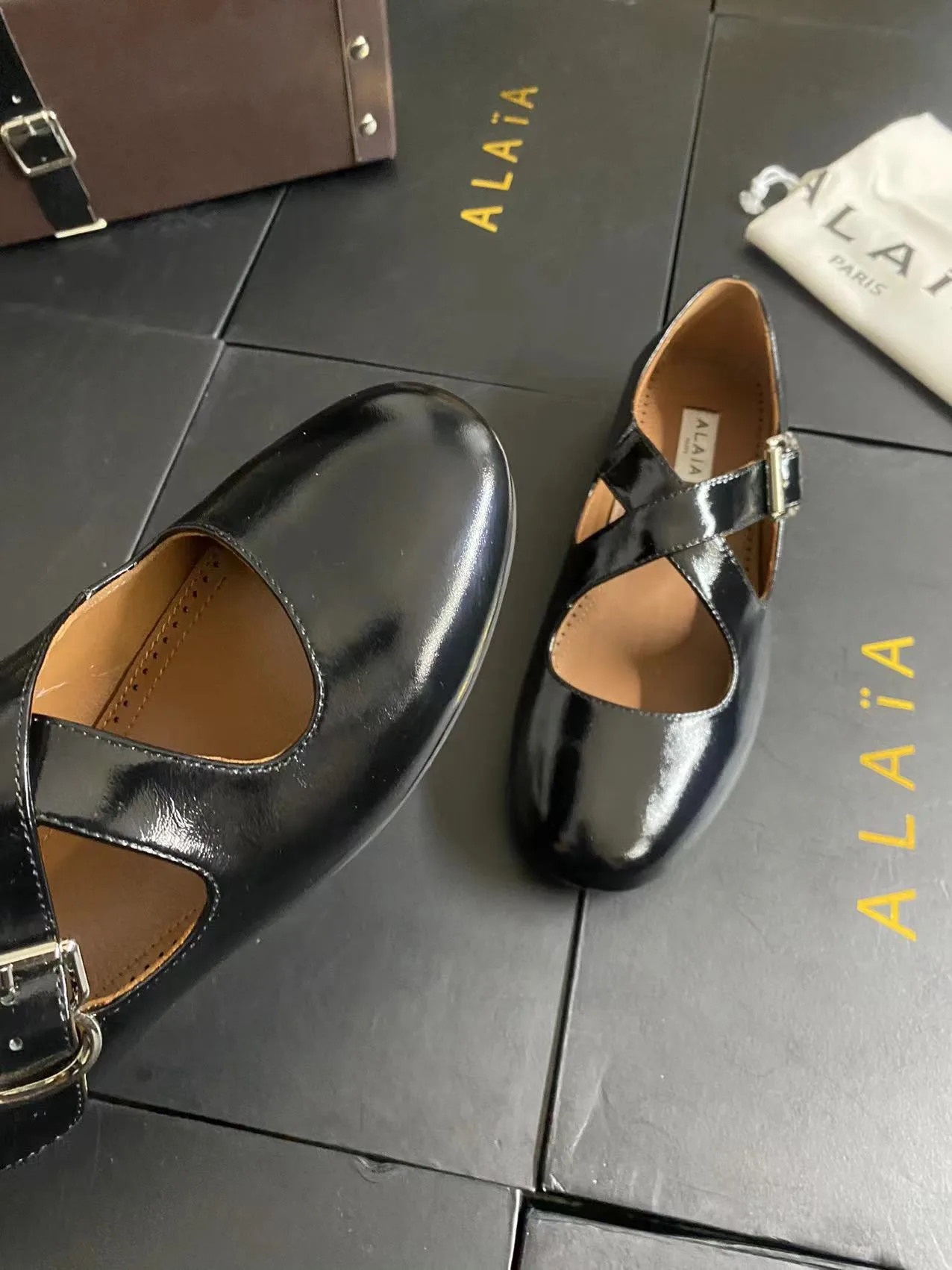 Alaia Cowhide Sheepskin Glossy Square-Toe Buckle Cross-Strap Flats in Black · view 8