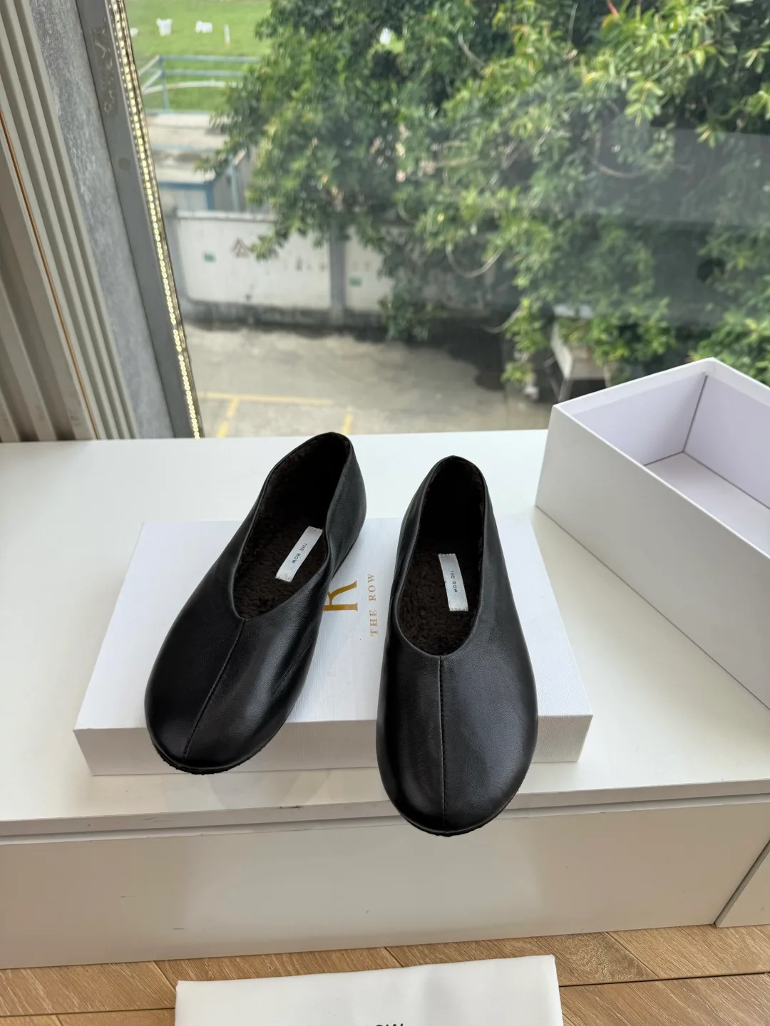 The Row Cowhide Smooth Round-Toe Ballet Flats in Black · view 1
