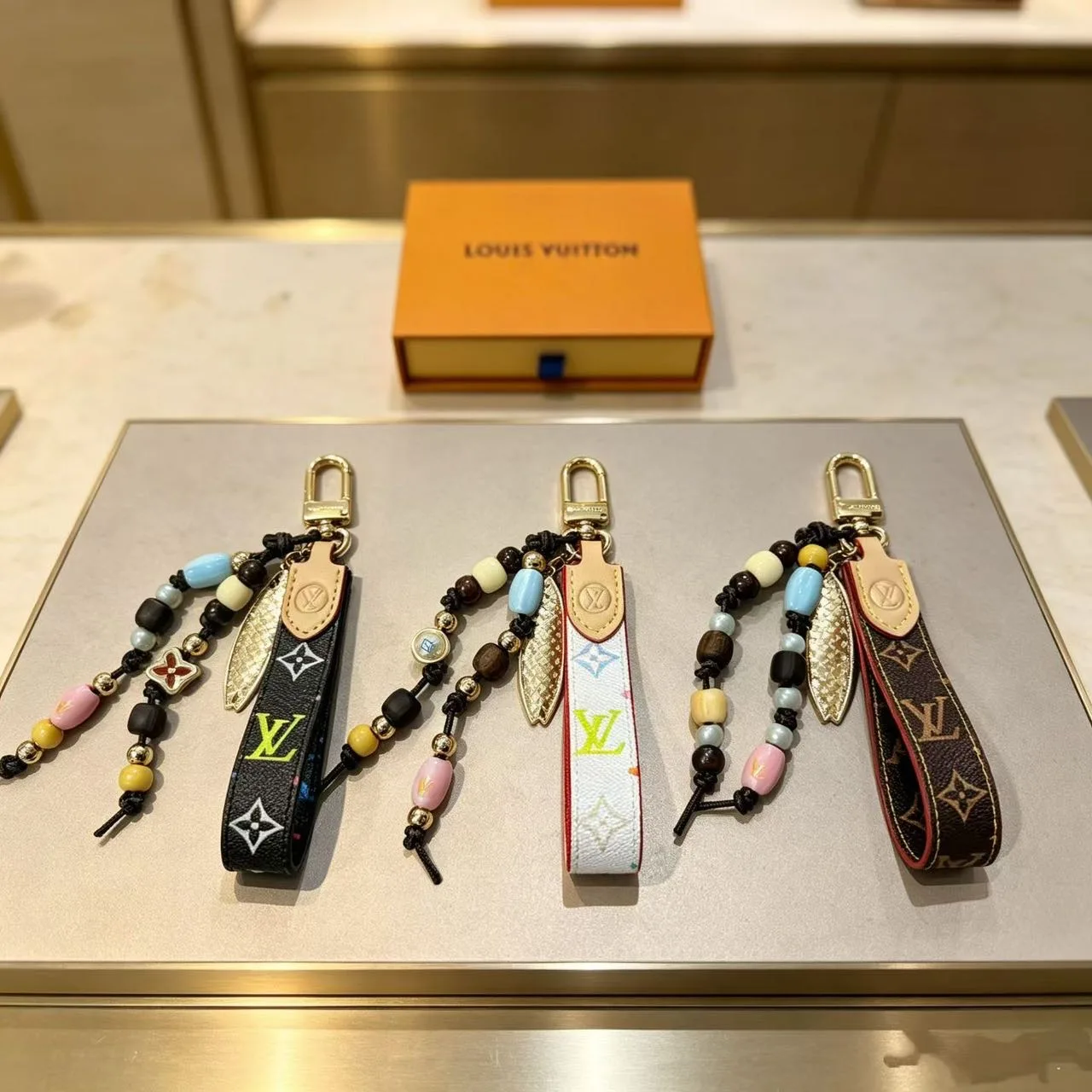 Louis Vuitton Beaded Wrist Strap Keychain in Black & White & Brown · view 1