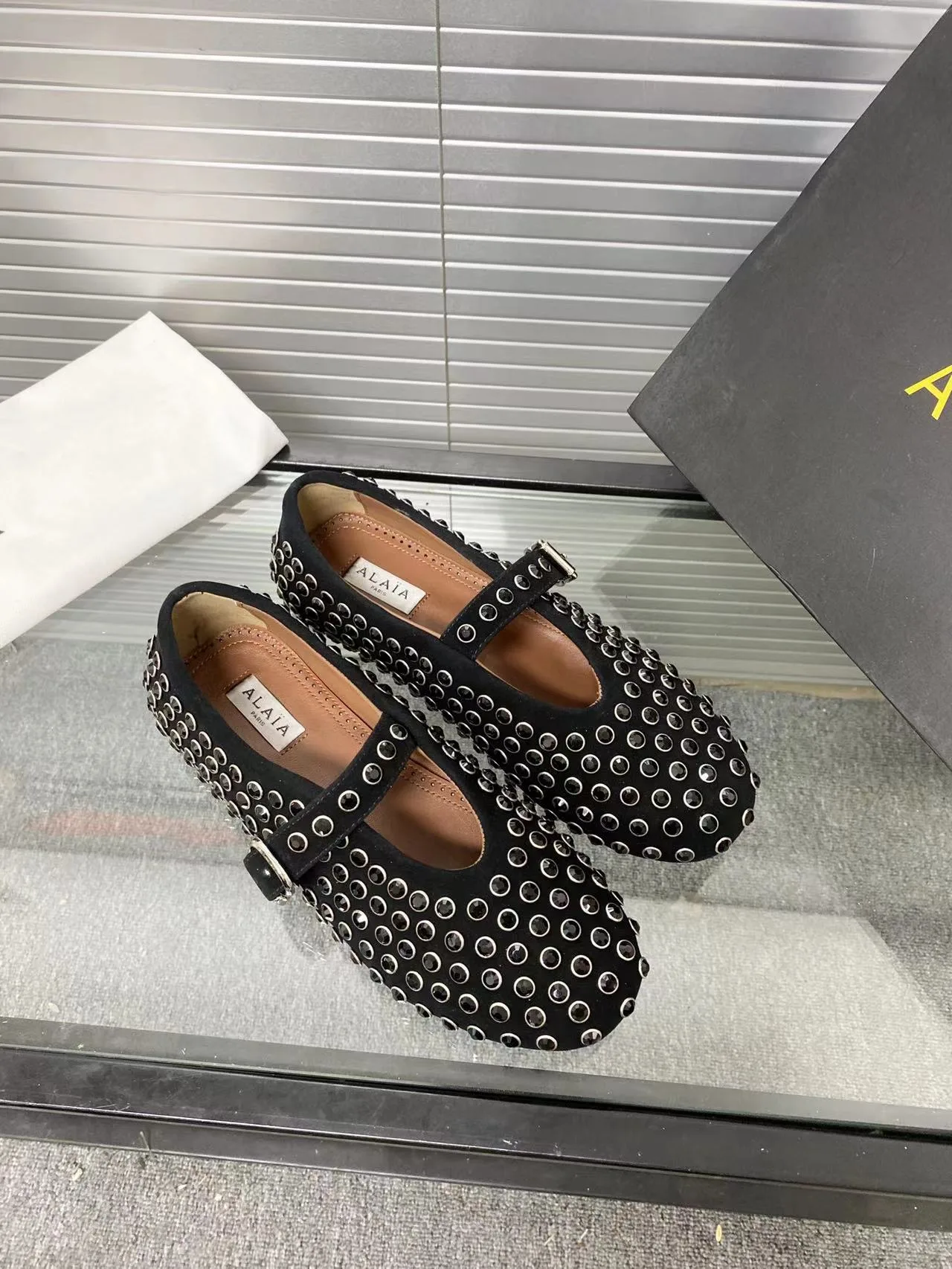 Alaia Cowhide Sheepskin Round-Toe Studded Mary Jane Flats in Black · view 1