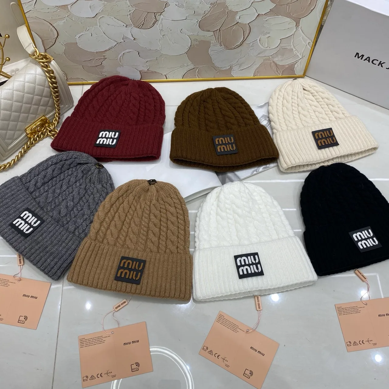 Miu Miu Cable-knit logo beanie in Black & White & Grey & Tan & Cream & Burgundy & Brown · view 8