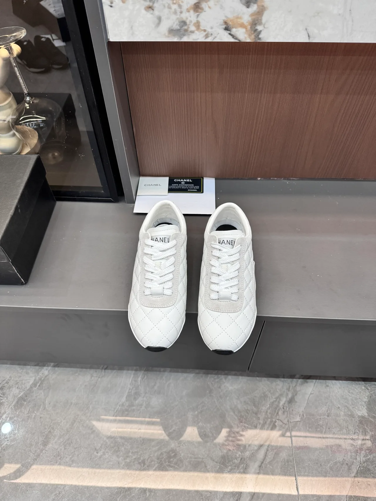 Chanel Quilted Glossy Sneakers in White · view 1