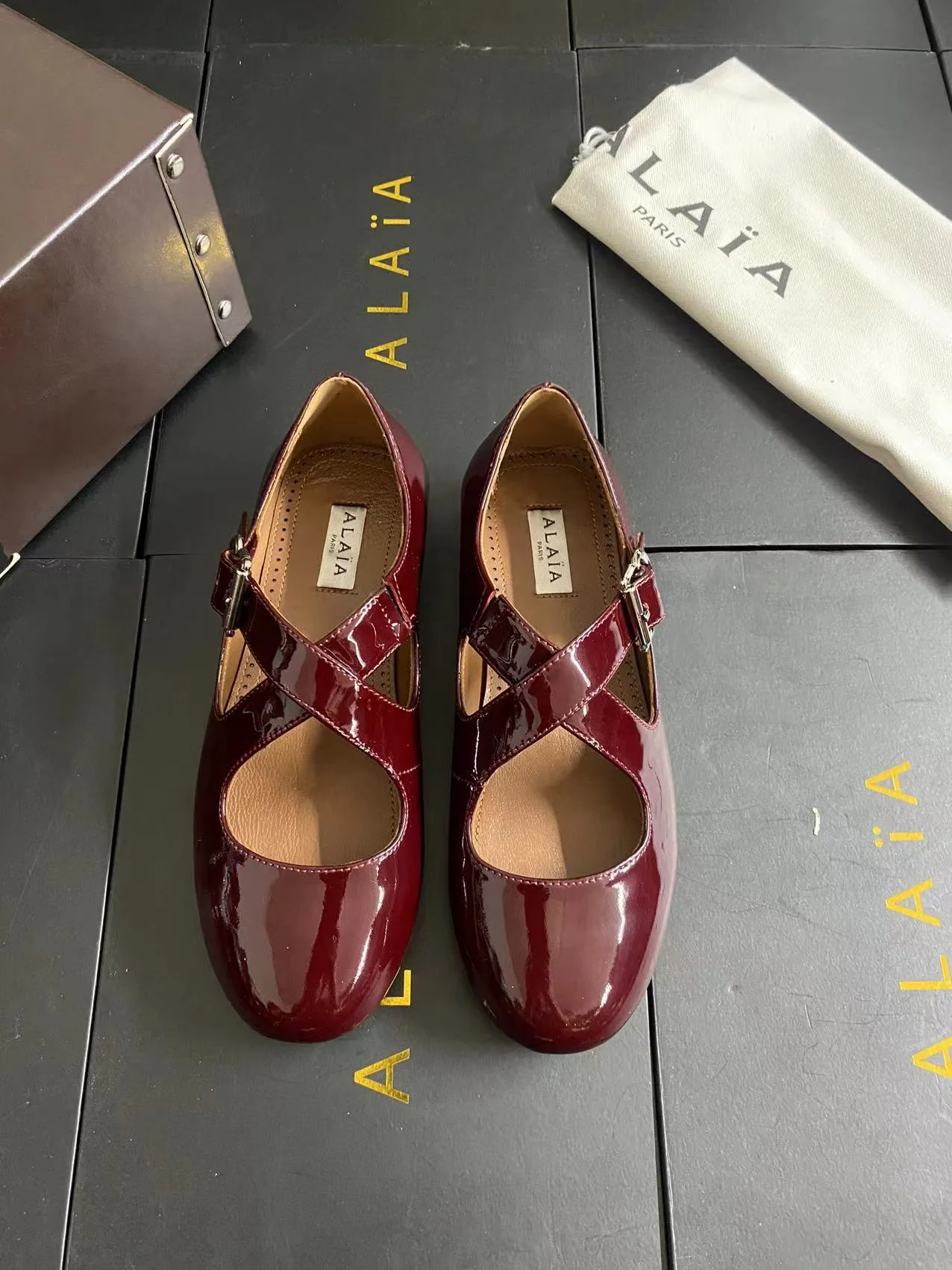 Alaia Cowhide Sheepskin Glossy Square-Toe Buckle Cross-Strap Mary Jane Flats in Burgundy · view 1
