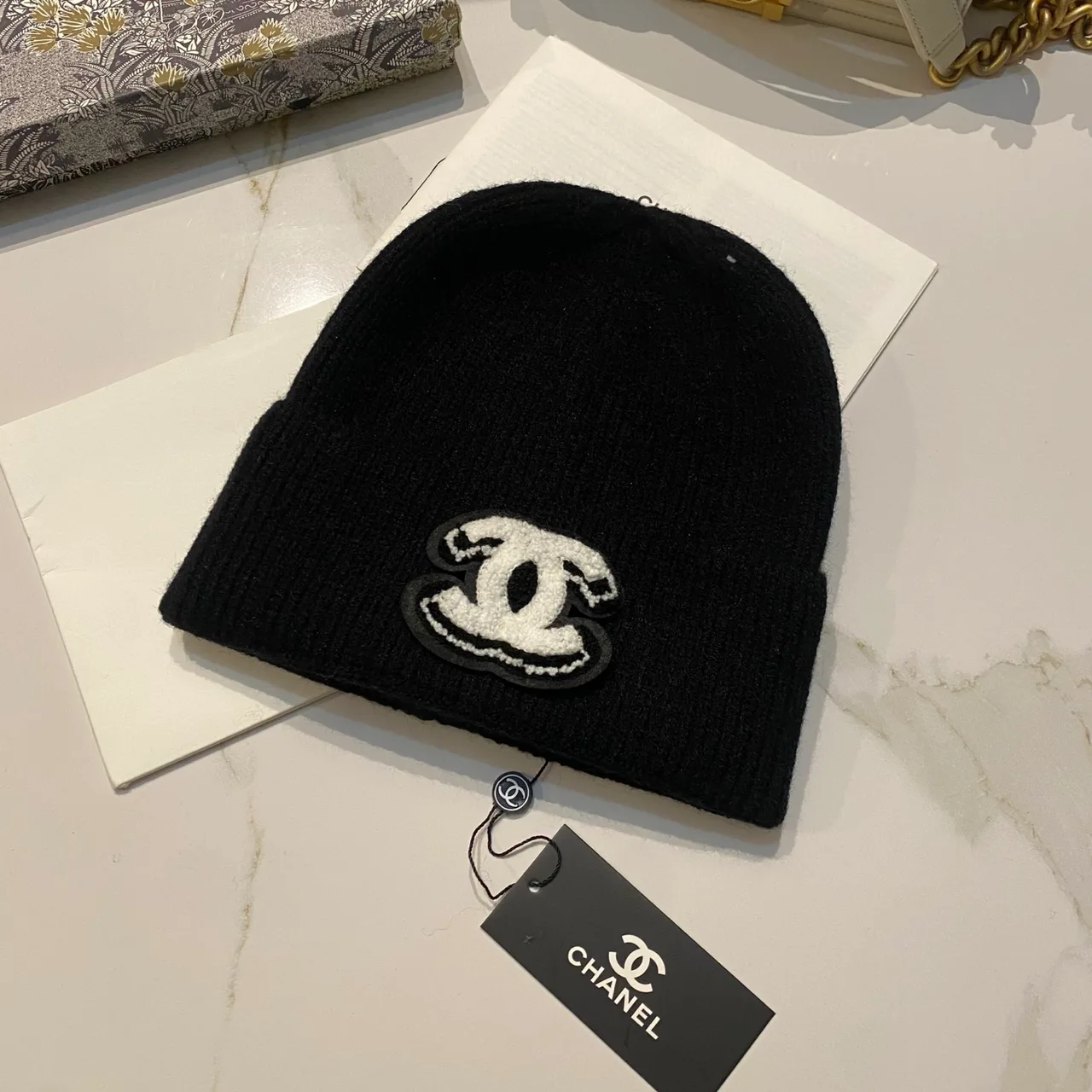 Chanel CC knit beanie in Black / White / Red / Grey / Beige / Tan · view 1