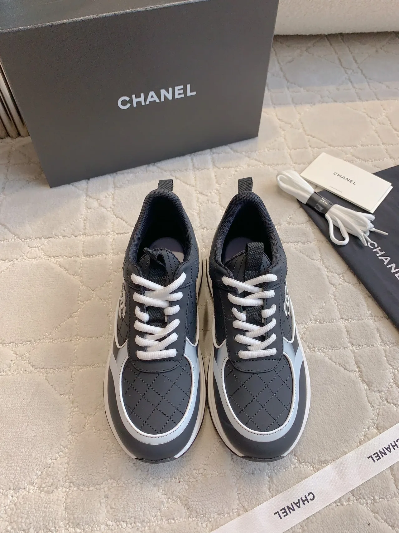 Chanel Quilted Sneakers in Black · view 1