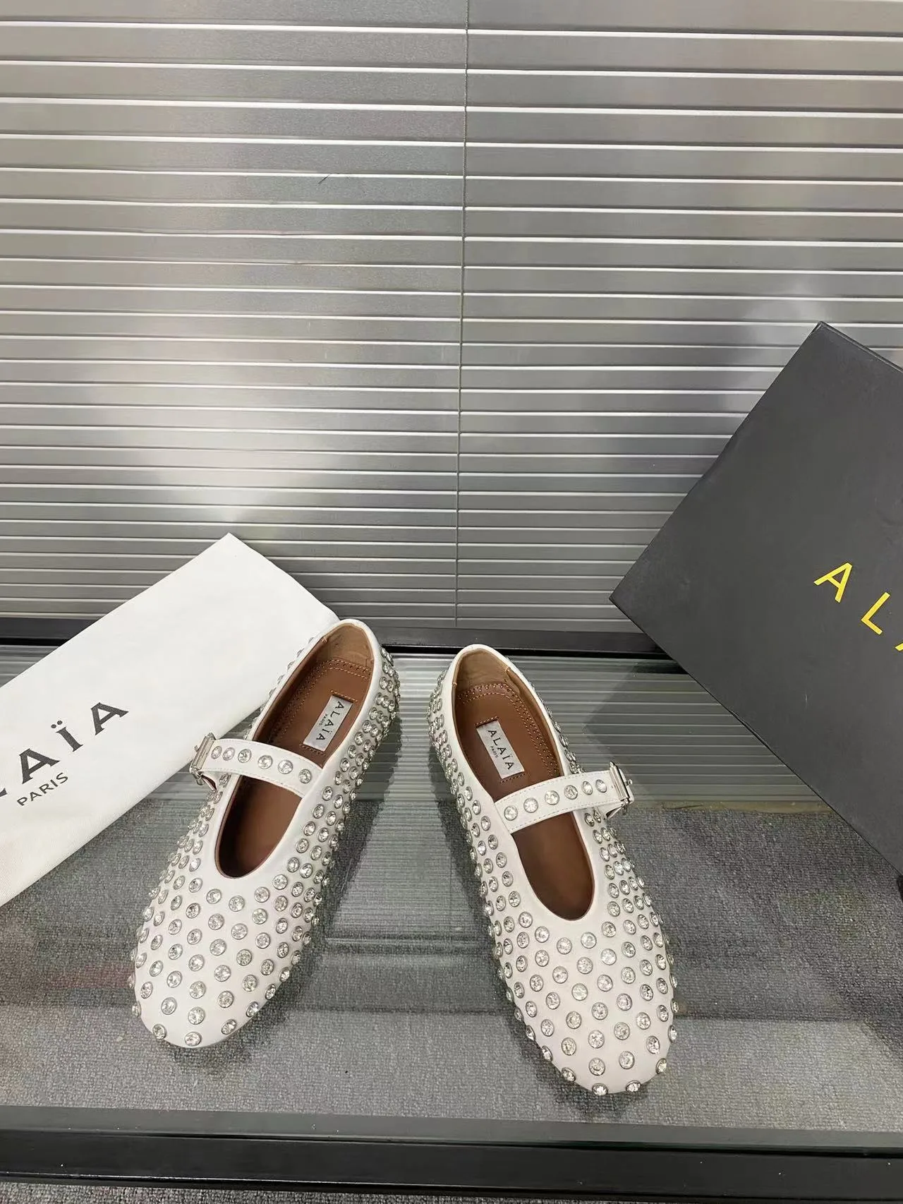 Alaia Cowhide Sheepskin Glossy Round-Toe Buckle Studded Mary Jane Flats in White · view 7