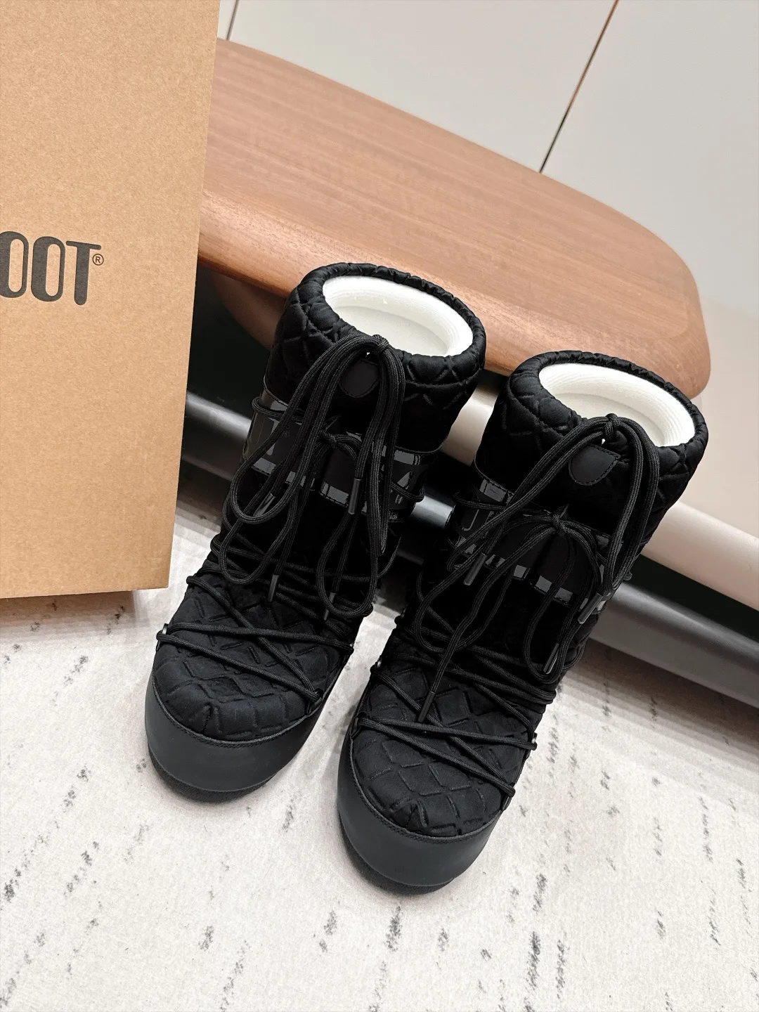 Moon Boot Glossy Quilted Snow Boots in Black · view 1