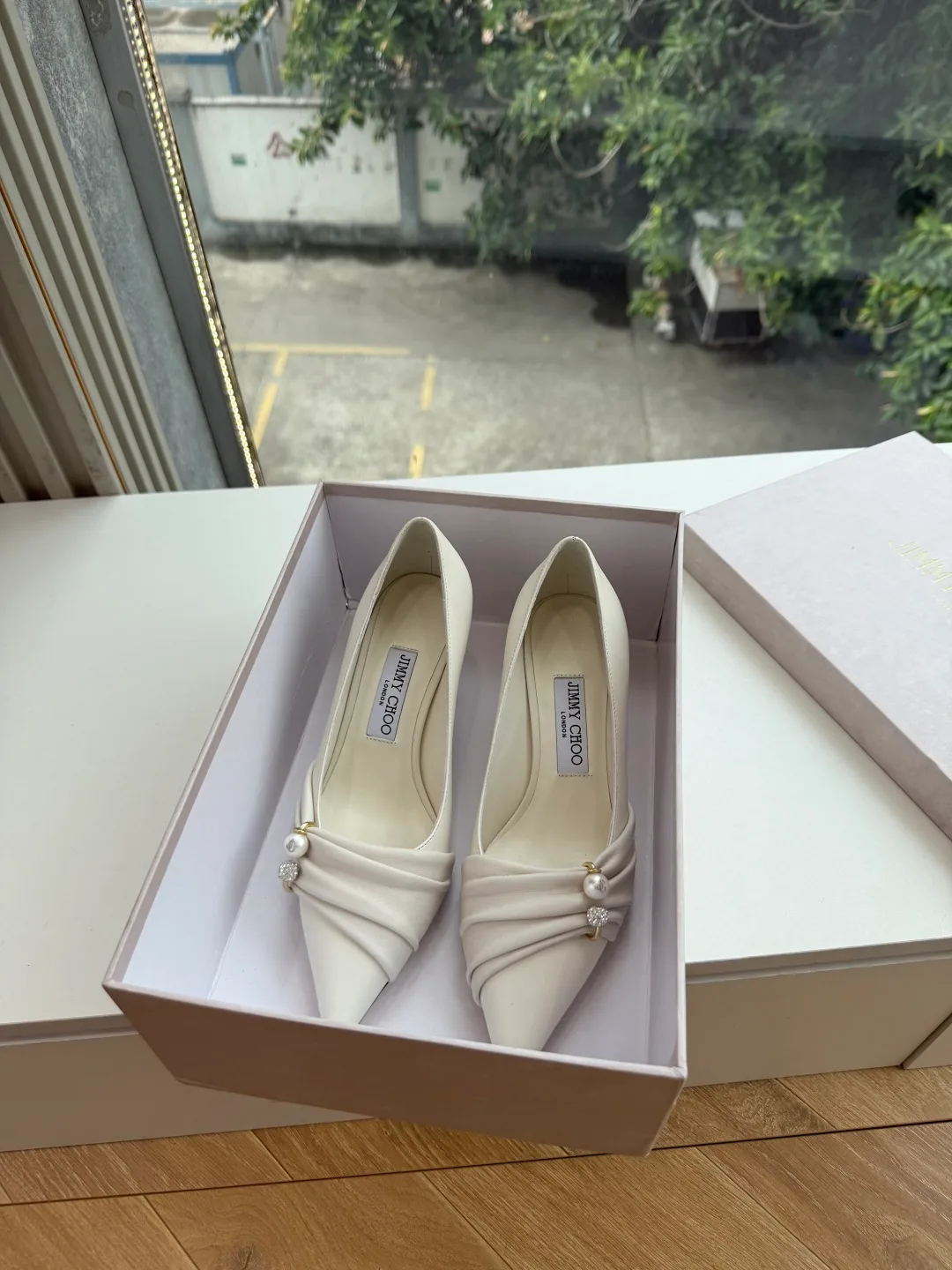 Jimmy Choo Glossy Pointed-Toe Knotted Pointed Pumps in White · view 1