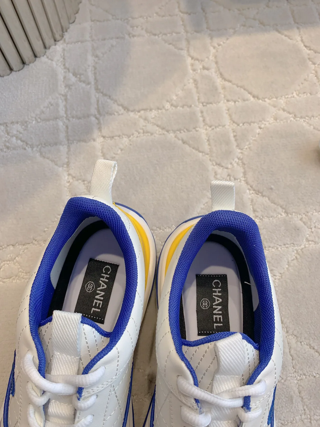 Chanel Quilted Sneakers in White · view 6