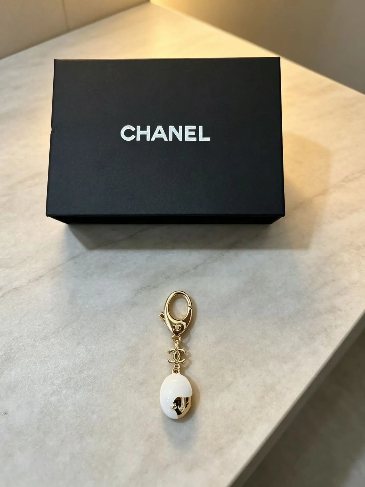 Chanel Half-Face Pendant Keychain in White · view 1