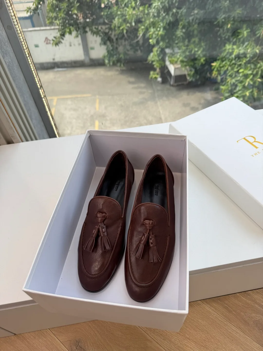 The Row Cowhide Glossy Round-Toe Tassel Loafers in Brown · view 3